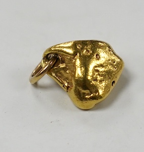 A yellow metal nugget pendant, approx. 13mm, 7.3 grams. Condition - good